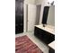 Bathroom featuring double sinks with black cabinets, tiled floors and black hardware at 5851 Swan Walk, Sugar Hill, GA 30518