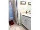 Bathroom featuring white cabinets, framed art, and tiled floors at 5851 Swan Walk, Sugar Hill, GA 30518