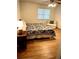 Comfortable bedroom features a cozy chair, laminate floors, and a window at 5851 Swan Walk, Sugar Hill, GA 30518