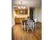 The dining area offers a built-in cabinet, table, and hardwood floors at 5851 Swan Walk, Sugar Hill, GA 30518