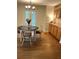 Dining area features a hardwood floor, round table, open glass doors, and a built-in cabinet at 5851 Swan Walk, Sugar Hill, GA 30518
