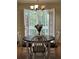 Bright dining area with doors leading to the deck and a view of the backyard at 5851 Swan Walk, Sugar Hill, GA 30518