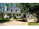Charming two-story home with a welcoming front porch and landscaped front yard at 5851 Swan Walk, Sugar Hill, GA 30518