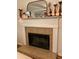 Close-up of the fireplace with a white mantel and decorative accessories against a neutral wall at 5851 Swan Walk, Sugar Hill, GA 30518
