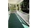 Green painted porch floor with white railings, providing a cozy outdoor space and views at 5851 Swan Walk, Sugar Hill, GA 30518