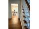 Hallway view with hardwood floors leading to dining area at 5851 Swan Walk, Sugar Hill, GA 30518