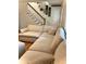 Comfortable living room featuring a large sectional sofa and staircase at 5851 Swan Walk, Sugar Hill, GA 30518