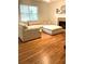 Spacious living room with hardwood floors, a fireplace, and a comfortable seating area at 5851 Swan Walk, Sugar Hill, GA 30518