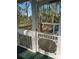 An inviting screened-in porch with traditional touches, overlooking a peaceful backyard area at 5851 Swan Walk, Sugar Hill, GA 30518