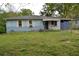Charming light blue home with white shutters and covered porch, set on a grassy lot at 6232 Hospital Way, Douglasville, GA 30134