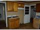 Compact kitchen features upper and lower wooden cabinets plus laminate countertops at 6232 Hospital Way, Douglasville, GA 30134