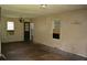 Bare living room with hardwood floors, a vintage chandelier, and natural light from the windows at 6232 Hospital Way, Douglasville, GA 30134