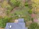 Aerial view of property featuring a patio area, lush landscape, and wooded area at 7405 Richmond Way, Cumming, GA 30040