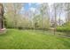 The backyard boasts a well-kept lawn and a fence line surrounding the property at 7405 Richmond Way, Cumming, GA 30040