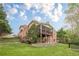 Beautiful brick home surrounded by greenery; featuring a screened-in porch and patio at 7405 Richmond Way, Cumming, GA 30040