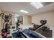 Basement home gym equipped with exercise machines and free weights at 7405 Richmond Way, Cumming, GA 30040