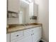 This bathroom features a granite countertop and white cabinets for ample storage and modern convenience at 7405 Richmond Way, Cumming, GA 30040
