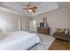 Bedroom with neutral walls, ceiling fan, modern dresser and an accent rug at 7405 Richmond Way, Cumming, GA 30040