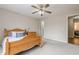 Bedroom with a wood bed frame, neutral walls, and carpet flooring creates a cozy, inviting space at 7405 Richmond Way, Cumming, GA 30040