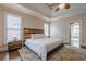 Cozy bedroom with tray ceiling, neutral walls, and a large bed at 7405 Richmond Way, Cumming, GA 30040