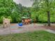 A community playground featuring a variety of play structures including slides, climbing walls, and spring riders at 7405 Richmond Way, Cumming, GA 30040
