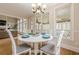 Cozy dining room featuring a white table, chandelier, and sunny windows at 7405 Richmond Way, Cumming, GA 30040
