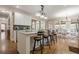 Spacious kitchen with granite countertops, a breakfast bar, and modern appliances at 7405 Richmond Way, Cumming, GA 30040