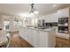 Well-equipped kitchen featuring granite countertops, stainless steel appliances, and a breakfast area at 7405 Richmond Way, Cumming, GA 30040