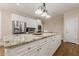 Bright kitchen with stainless steel appliances, a large island, and white cabinetry at 7405 Richmond Way, Cumming, GA 30040