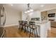Spacious kitchen with a large island, barstool seating, and hardwood flooring at 7405 Richmond Way, Cumming, GA 30040