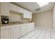 Functional kitchenette with white cabinets, granite countertops, and tile flooring, perfect for a lower level at 7405 Richmond Way, Cumming, GA 30040