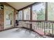 Screened patio with brick accents, outdoor furniture, and a view of the home and surrounding greenery at 7405 Richmond Way, Cumming, GA 30040