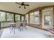 Covered patio with brick features, ceiling fan, outdoor lighting, and seating arrangements at 7405 Richmond Way, Cumming, GA 30040