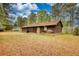 Backyard featuring a wood-sided home surrounded by mature trees at 2140 Teri Ln, Conyers, GA 30013