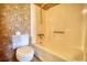 Compact bathroom with shower-tub combo featuring floral wallpaper at 2140 Teri Ln, Conyers, GA 30013