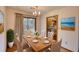 Cozy dining room with natural light, a wooden table, and seating for six, adjacent to the kitchen at 2140 Teri Ln, Conyers, GA 30013