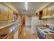 Well-lit kitchen features older appliances, tile floors, and wood cabinets at 2140 Teri Ln, Conyers, GA 30013
