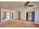 Open living room featuring sliding glass doors to backyard and a ceiling fan at 2140 Teri Ln, Conyers, GA 30013