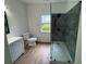 Updated bathroom features a glass shower, toilet, and vanity with wood look flooring at 437 Collier Ridge Nw Dr, Atlanta, GA 30318