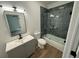 Stylish bathroom with a modern vanity, toilet, and a sleek glass-enclosed bathtub/shower combination at 437 Collier Ridge Nw Dr, Atlanta, GA 30318