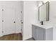 Bathroom vanity with gray cabinet, white countertop, and modern black fixtures at 437 Collier Ridge Nw Dr, Atlanta, GA 30318