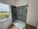 Modern bathroom featuring a tiled shower with a glass door and window with natural light at 437 Collier Ridge Nw Dr, Atlanta, GA 30318