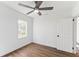 Well-lit bedroom showcasing wood floors, a ceiling fan, and a window offering natural light at 437 Collier Ridge Nw Dr, Atlanta, GA 30318