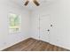 A bright bedroom with wood-look floors, a window and a door at 437 Collier Ridge Nw Dr, Atlanta, GA 30318