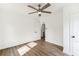 Bright bedroom with wood-look floors, white walls, ceiling fan and doors at 437 Collier Ridge Nw Dr, Atlanta, GA 30318