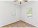 Bright bedroom with wood-look floors, white walls, ceiling fan and two windows at 437 Collier Ridge Nw Dr, Atlanta, GA 30318