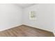 Bright, minimalist bedroom with natural light and wood-look flooring at 437 Collier Ridge Nw Dr, Atlanta, GA 30318