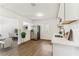 Bright kitchen flowing to dining room featuring white cabinets, quartz countertops, and stainless appliances at 437 Collier Ridge Nw Dr, Atlanta, GA 30318