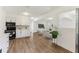 Open floor plan with modern kitchen and living room featuring white cabinets and stainless appliances at 437 Collier Ridge Nw Dr, Atlanta, GA 30318