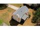 Aerial view of a two-story house with a screened in porch, a well-maintained lawn, and a driveway at 4814 Riveredge Cv, Snellville, GA 30039